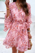 Floral wrap dress by Jade Icarus featuring long sleeves, vibrant floral pattern, and cinched waist for a stylish women&