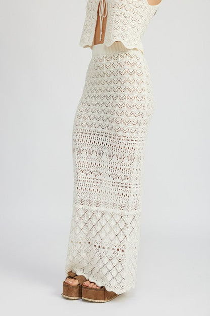 Fitted crochet maxi skirt with slit by Jade Icarus, showcasing intricate crochet pattern and stylish slit detail.