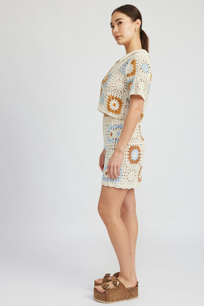 High waist crochet mini skirt by Jade Icarus, featuring detailed crochet pattern, styled with a trendy, fitted design.