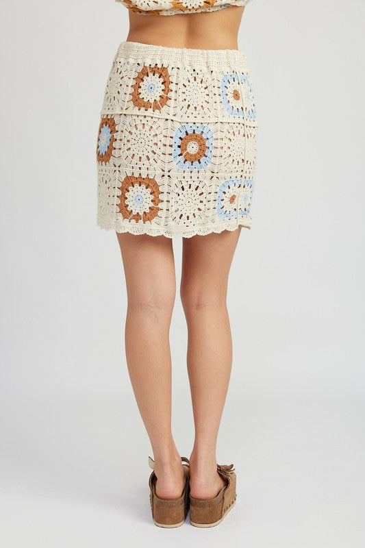 High waist crochet mini skirt from Jade Icarus, featuring intricate crochet details and a stylish, fitted design.