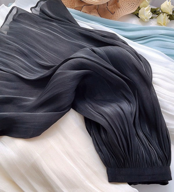 Women’s mid-length A-line skirt by Jade Icarus, featuring a flowy silhouette and neutral fabric, shown on a model.