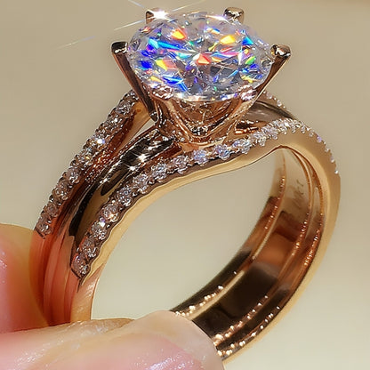 Pair of 18K gold moissanite rings from Carmine Juneberry showcasing elegant, versatile jewelry with sparkling gemstone accents.