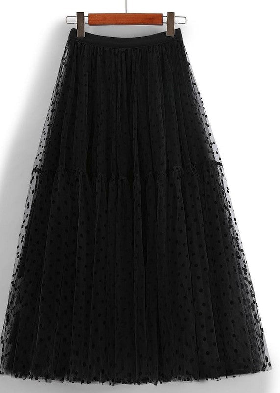 Polka dot midi skirt by Jade Icarus, featuring a classic black and white pattern, displayed on a hanger.