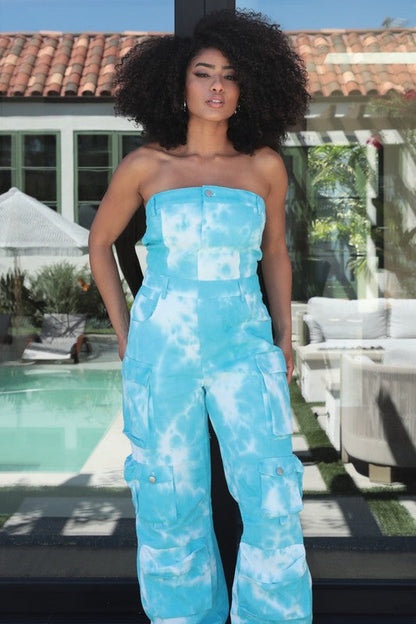 Blue tie dye strapless utility jumpsuit for women by Jade Icarus, featuring a relaxed fit and functional pockets.