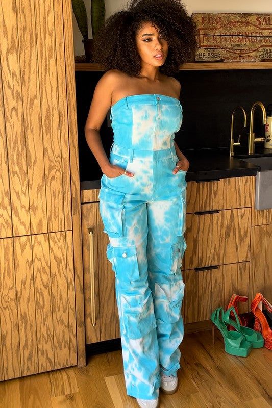 Blue tie dye strapless utility jumpsuit for women by Jade Icarus, featuring a relaxed fit and functional pockets.