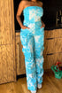 Blue tie-dye strapless utility jumpsuit for women by Jade Icarus, featuring a relaxed fit and utility-style design.