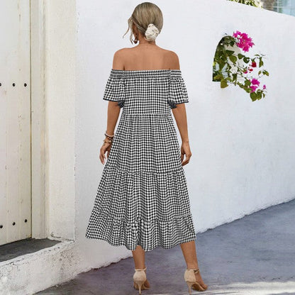 Image of a Jade Icarus summer plaid dress for women with puff sleeves, displayed on a mannequin or laid out on a flat surface.