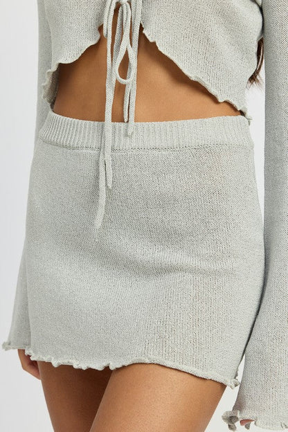 Jade Icarus lettuce hem crochet mini skirt, stylish fashion piece with lettuce hem design, shown in a detailed close-up shot.