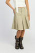 Automotive Jade Icarus knee-length pleated skirt with a smooth fabric finish, displayed on a mannequin.