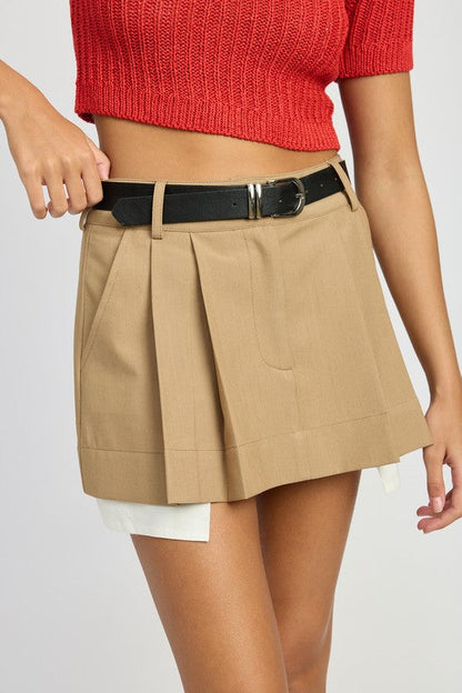Automotive Jade Icarus pleated mini skirt with sleek design, shown in a close-up image highlighting fabric details and style.