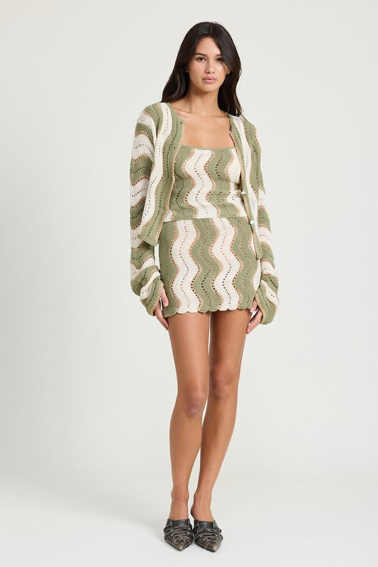Jade Icarus crochet mini skirt with elastic waistband, showcasing textured knit fabric and stylish fit on a model.