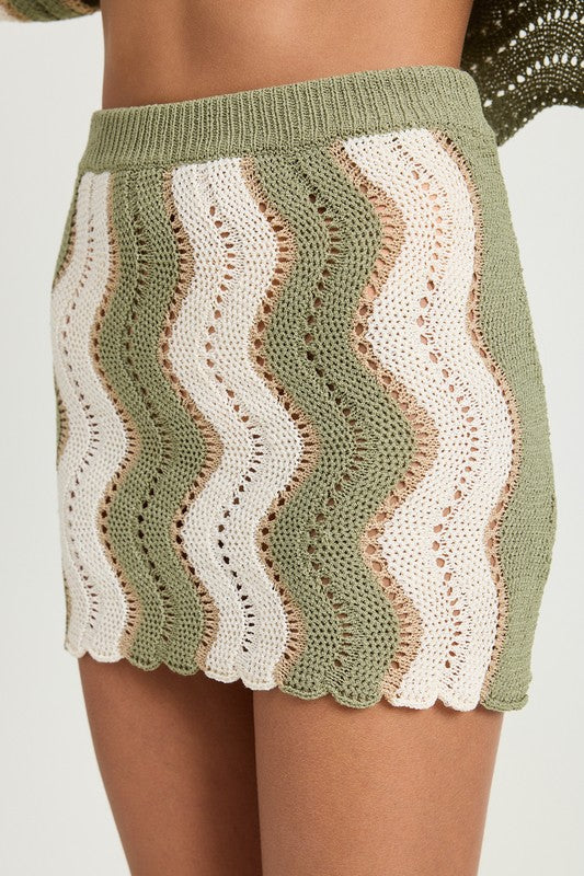 Jade Icarus crochet mini skirt with elastic waistband, showcasing detailed knit pattern and casual fit.