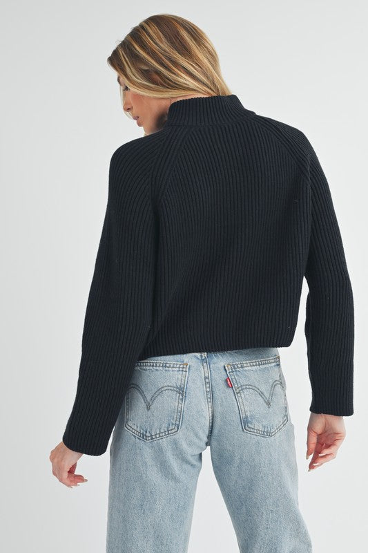 Jade Icarus Debbie half-zip sweater for women, soft knit fabric, light grey color, featuring a high collar and half-zip front.
