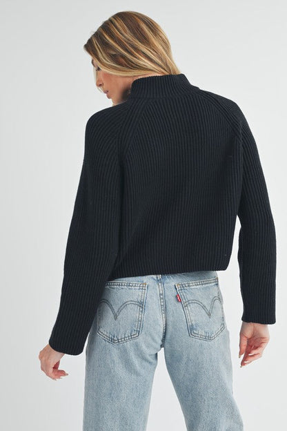 Jade Icarus Debbie half-zip sweater for women, soft knit fabric, light grey color, featuring a high collar and half-zip front.