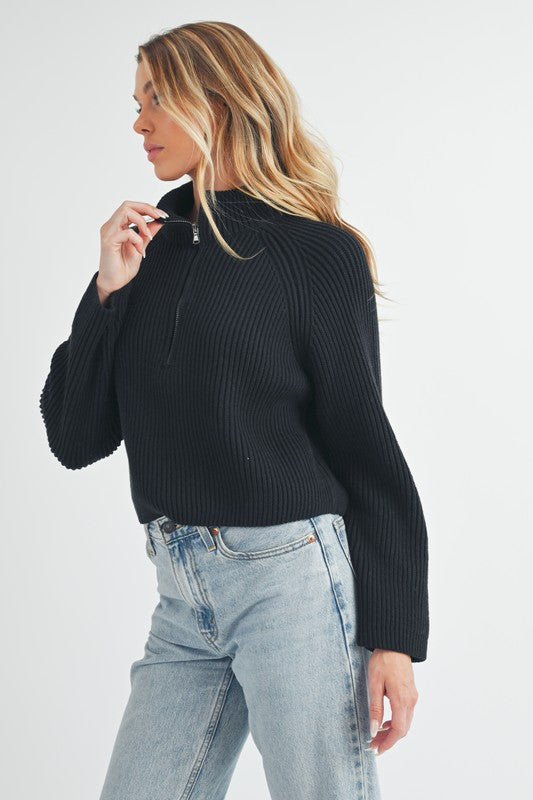Jade Icarus Debbie half-zip sweater for women, soft knit fabric, in a neutral color, featuring a high collar and half-zip front.