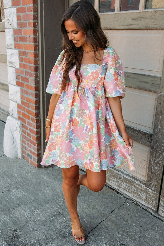 Women’s square neck puff sleeve babydoll dress by Jade Icarus, featuring a fitted bodice and flowy skirt, shown on a model.