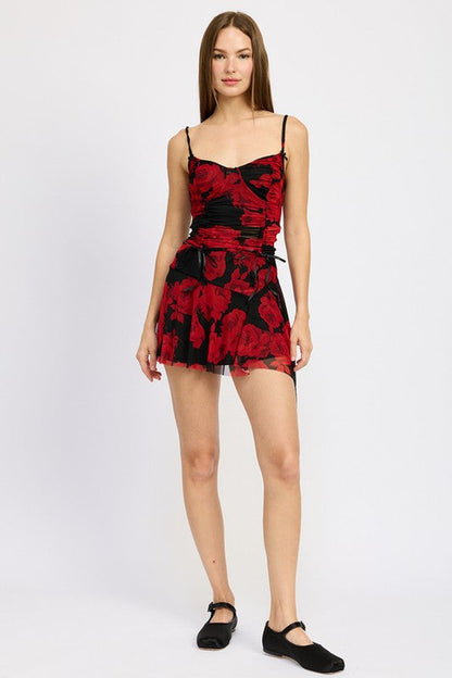 Jade Icarus asymmetrical sharkbite hem mini skirt in dark fabric, showcasing its stylish uneven hem and modern design.