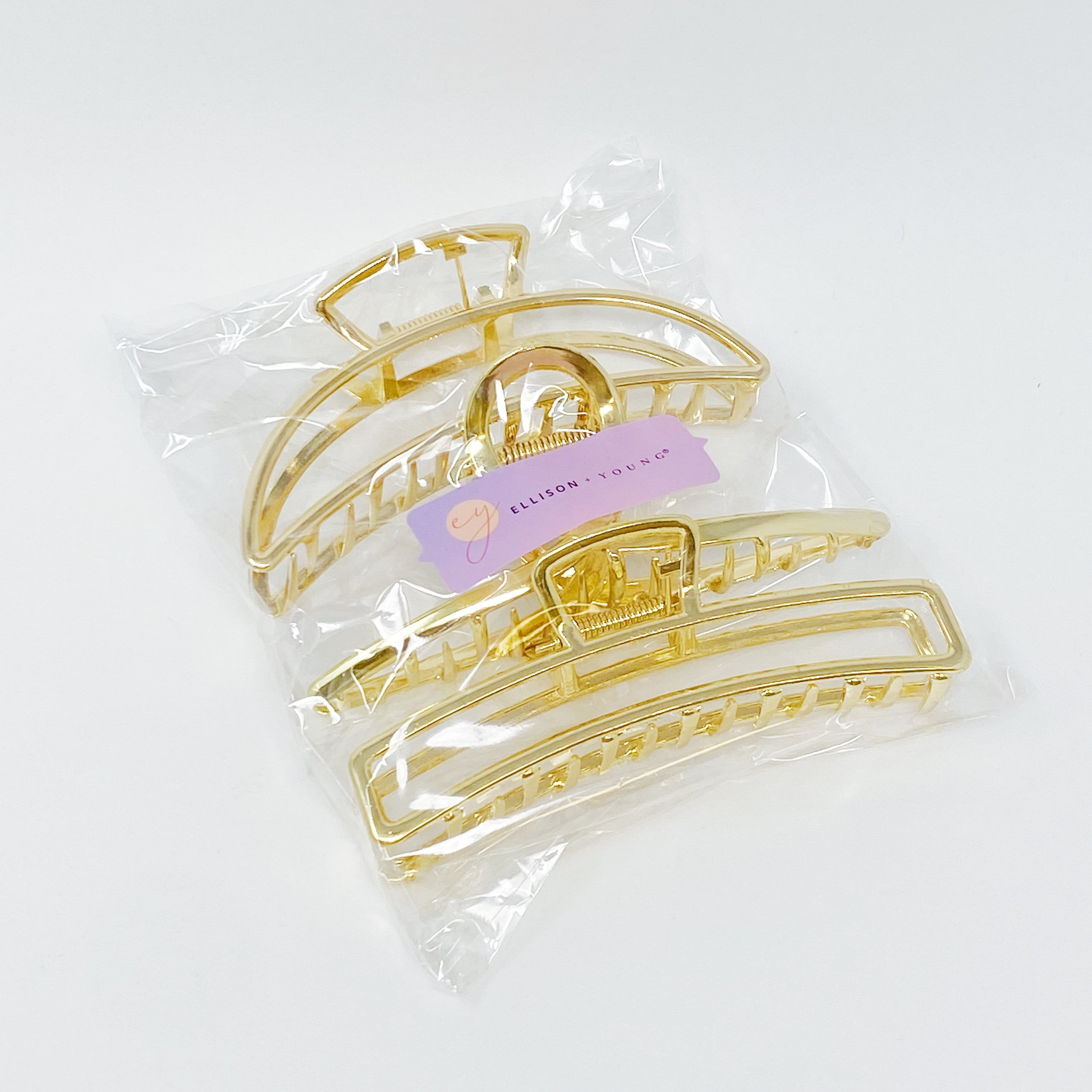 Set of three gold hair claws from Fuchsia Hercules, stylish jewelry accessories with claw-style design for hair styling.