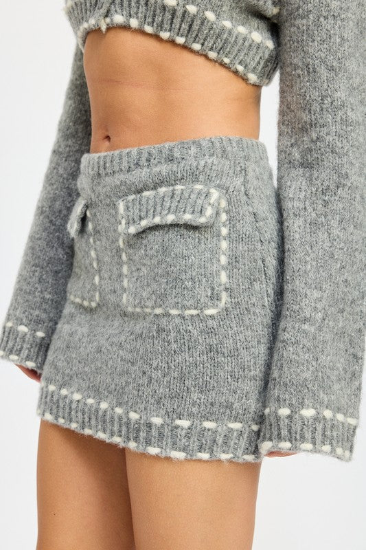 Automotive Jade Icarus knit mini skirt with contrast stitching, featuring detailed stitching and fabric texture.