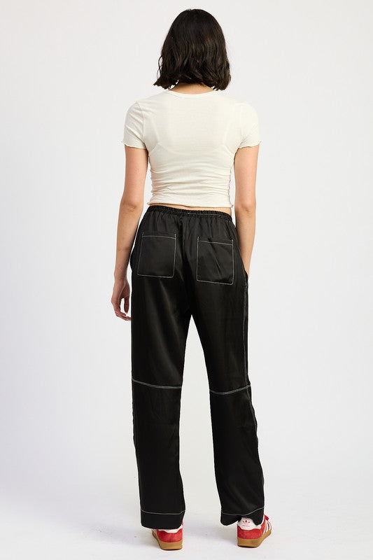 Jade Icarus satin lounge pants with contrast stitching, featuring a sleek, smooth fabric and stylish design.