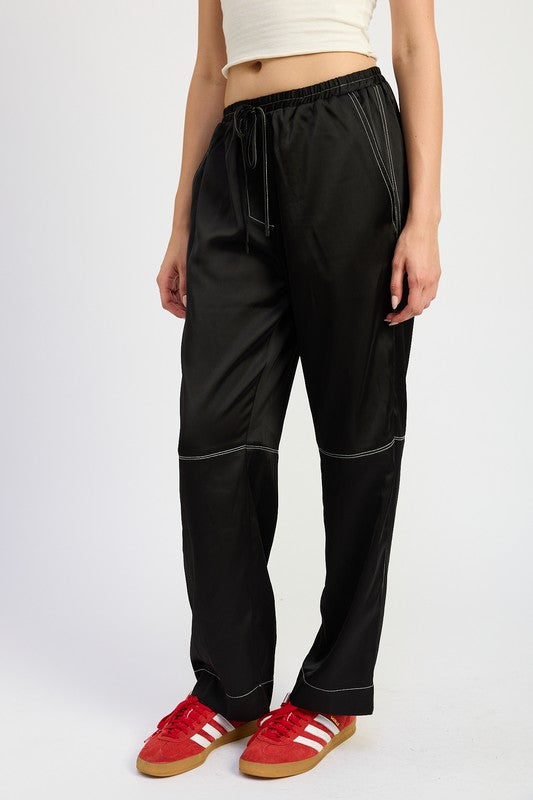 Automotive satin lounge pants by Jade Icarus featuring contrasting stitch details and a relaxed fit.