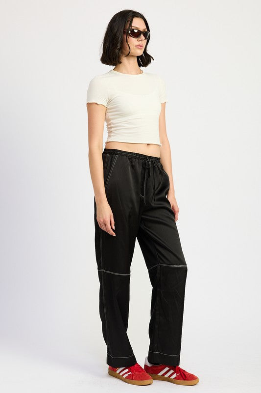Jade Icarus satin lounge pants with contrasting stitch detail, showcasing smooth fabric and relaxed fit in the automotive style.