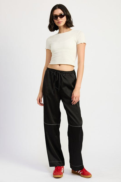 Jade Icarus satin lounge pants with contrasting stitch detail, featuring a relaxed fit and smooth fabric for comfortable wear.
