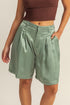 Satin high-waist pleated shorts from Jade Icarus with a stylish fit and glossy finish, designed for a modern, fashionable look.