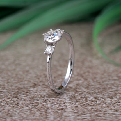 Sterling silver white moissanite 3-stone ring featuring sparkling gemstones and elegant design, crafted by Copper Juniper.