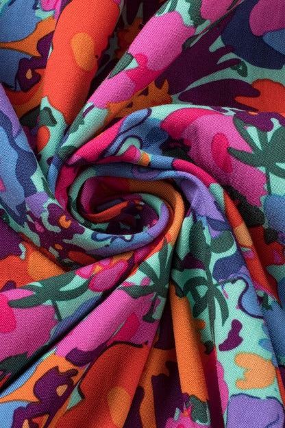 Women’s floral print V-neck wrap split maxi dress by Jade Icarus, featuring a flowing fabric and vibrant floral pattern.