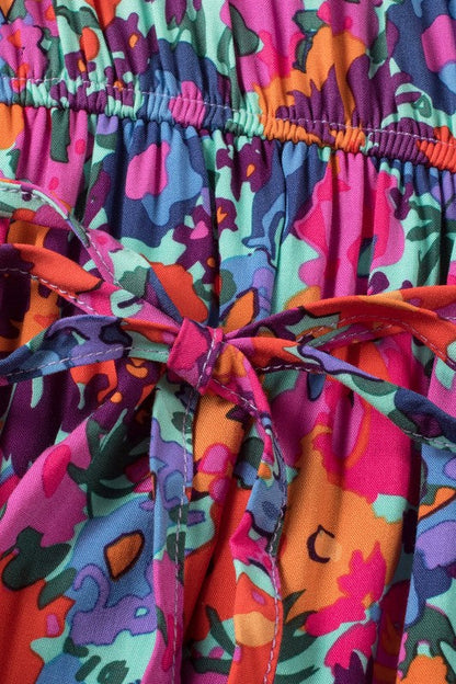 Women’s floral print V-neck wrap split maxi dress by Jade Icarus, flowing fabric with colorful flower patterns and a V neckline.