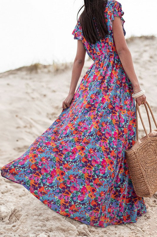 Women’s floral print V-neck wrap split maxi dress by Jade Icarus, featuring a colorful floral pattern and elegant V-neck design.