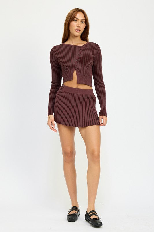 Close-up of Jade Icarus ribbed knit mini skirt featuring textured ribbing and fitted design, shown in a neutral color.
