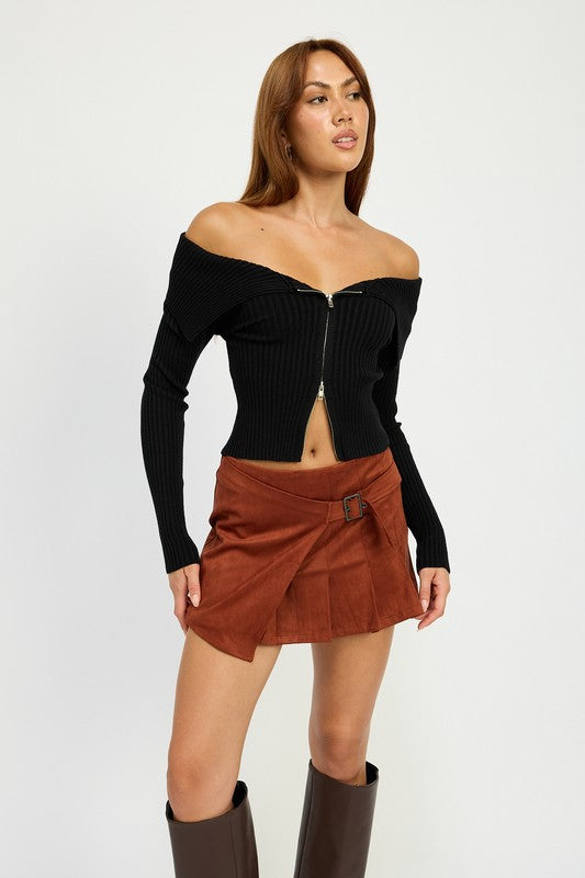 Jade Icarus wrapped buckle belt mini skirt in black fabric with front buckle detail, styled with a high waist and sleek fit.