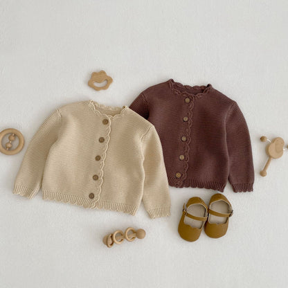 Baby unisex solid color crochet cardigan by Yellow Angel, cozy and stylish for kids and babies, shown in natural fabric detail.