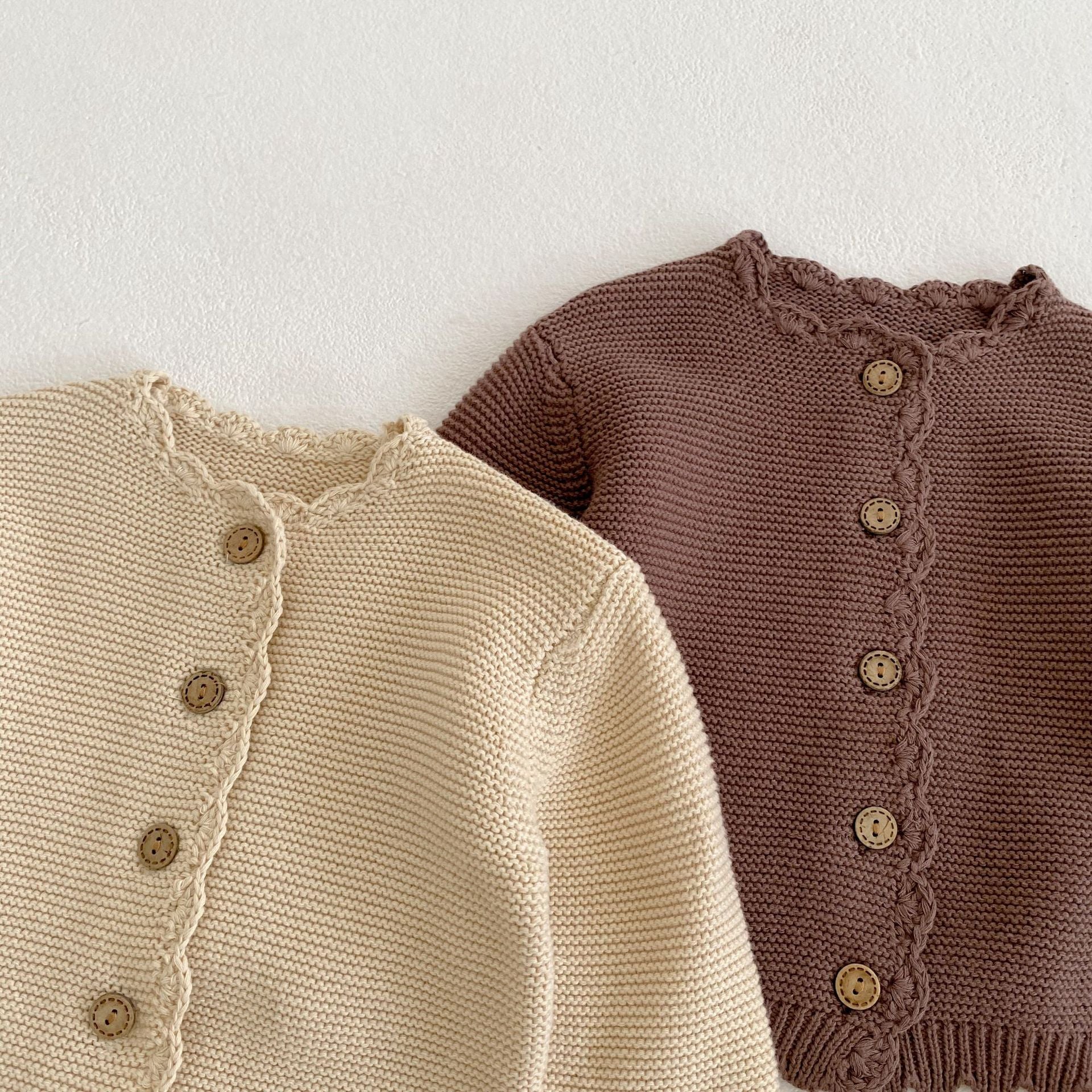 Baby unisex solid color crochet cardigan by Yellow Angel, soft knit sweater for kids and babies, front view with buttons.