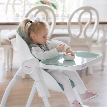 Ultramarine Dione Oribel Cocoon baby high chair with cushioned seat and safety harness for infant toddler feeding.