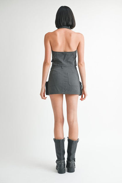 Jade Icarus exposed cargo pocket mini skirt with automotive-inspired design, featuring visible pockets and rugged fabric.