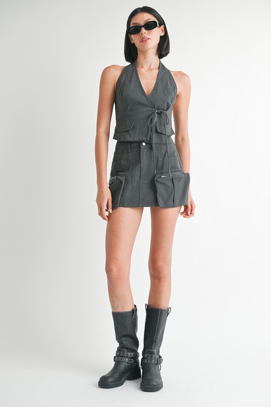 Jade Icarus exposed cargo pocket mini skirt in automotive style, featuring rugged fabric and multiple cargo pockets.