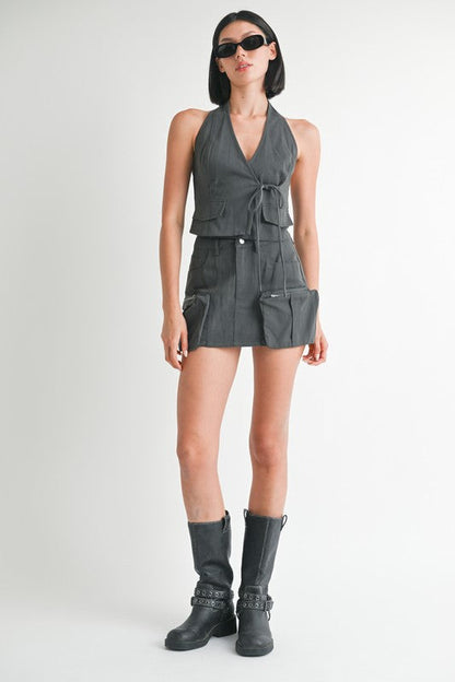 Jade Icarus exposed cargo pocket mini skirt in automotive style, featuring rugged fabric and multiple cargo pockets.