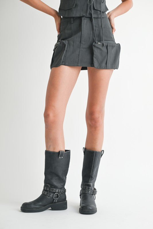 Jade Icarus exposed cargo pocket mini skirt with automotive design, featuring visible cargo pockets and detailed stitching.