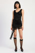 Asymmetrical satin mini skirt with lace detail from Jade Icarus, shown in a fashion photoshoot setting.