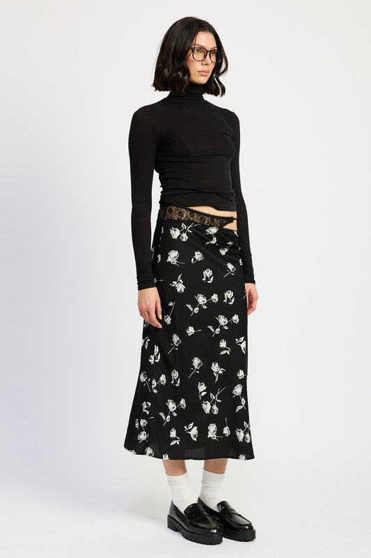 Asymmetrical satin maxi skirt by Jade Icarus with mixed media design and flowing silhouette, shown in a natural pose.