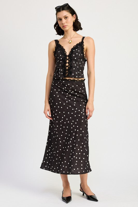 Jade Icarus satin midi skirt with lace trim, shown in a stylish fashion pose, highlighting the elegant fabric and delicate lace detail.