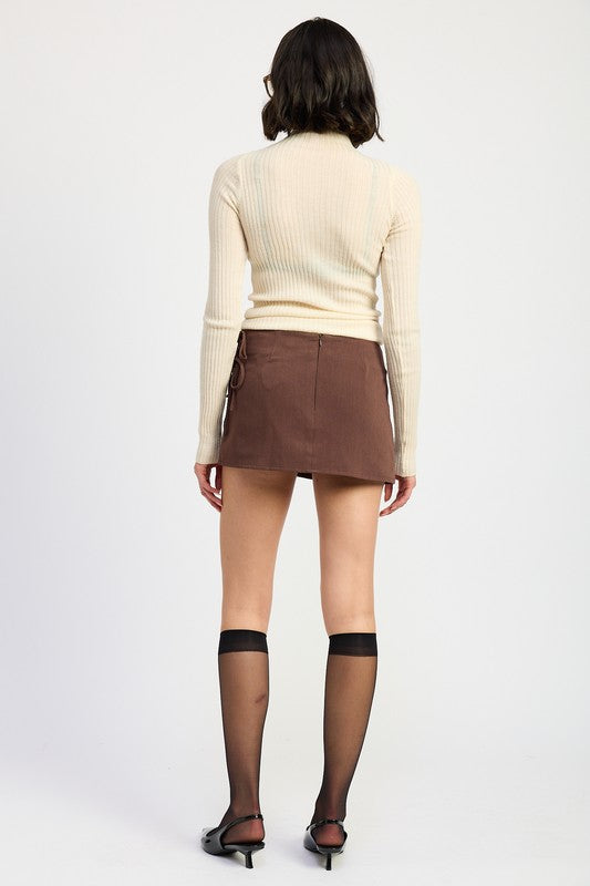 Automotive mini low-waisted skirt with ribbon ties by Jade Icarus, featuring a sleek design and decorative ribbon accents.