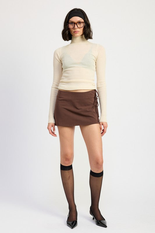 Automotive mini low-waisted skirt with ribbon ties, featuring Jade Icarus branding and stylish design details.
