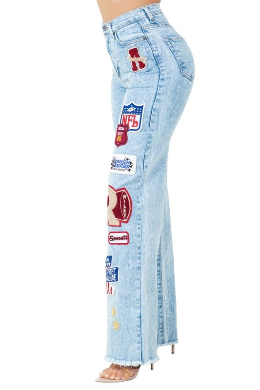 Jade Icarus Brook Varsity Jean in Light Wash, automotive style, showcasing light blue denim with varsity-inspired stitching details.