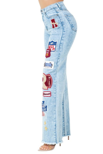 Jade Icarus Brook Varsity Jean in Light Wash, automotive style, showcasing light blue denim with varsity-inspired stitching details.