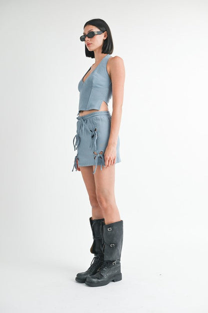 Jade Icarus French Terry Cutout Mini Skirt with stylish cutout design and soft fabric, displayed on a model.