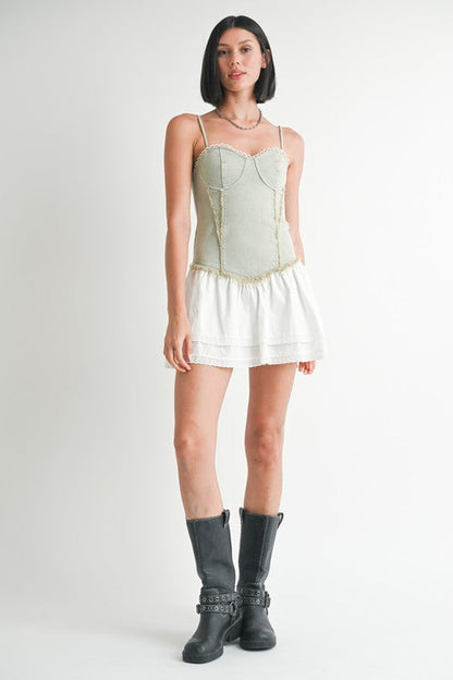Mini sleeveless denim dress by Jade Icarus, featuring a casual fit with shoulder straps and classic denim fabric.